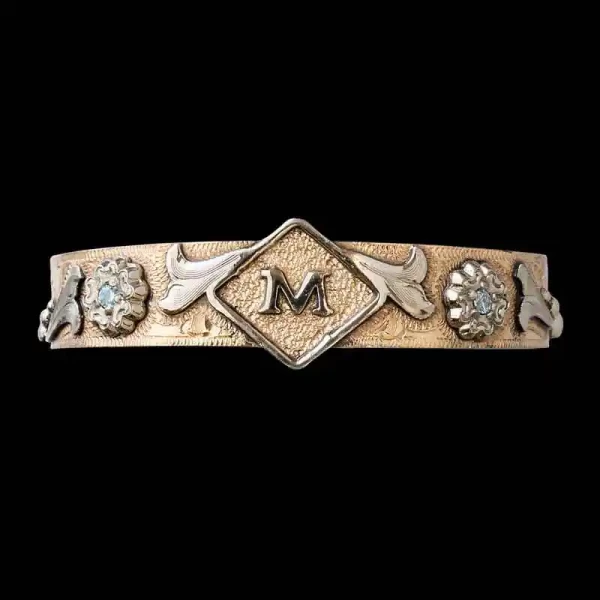 Celebrate your loved ones with the golden Wynonna Western Cuff Bracelet, featuring a matted Jeweler's Bronze base with silver details and customizable stones. Order it now!